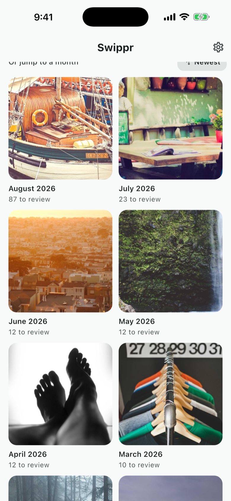 Swippr's month grid: August 2026 with 87 to review, July 2026 with 23, June and May 2026 with 12 each, April 2026 with 12 and March 2026 with 10, every month covered by a real photo taken in it