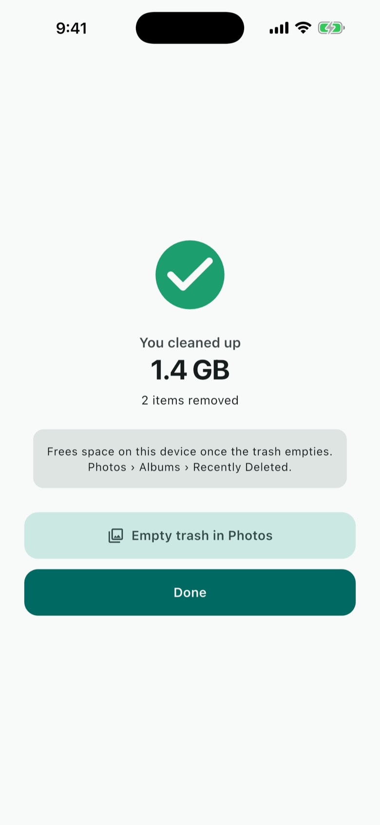 Swippr confirming 1.4 GB cleaned up and 2 items removed, with a button to empty the trash in Photos